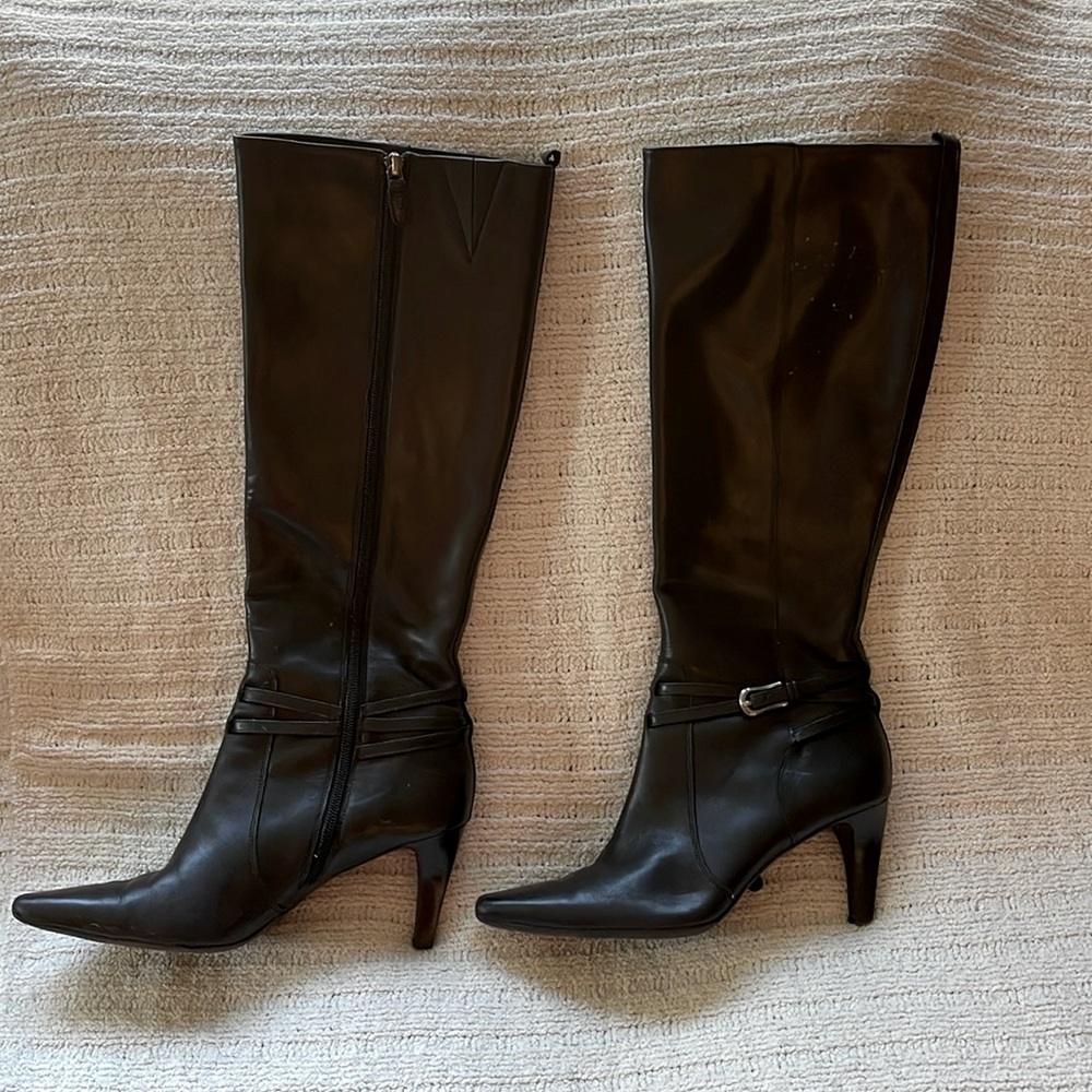 Tall high heeled black leather boots